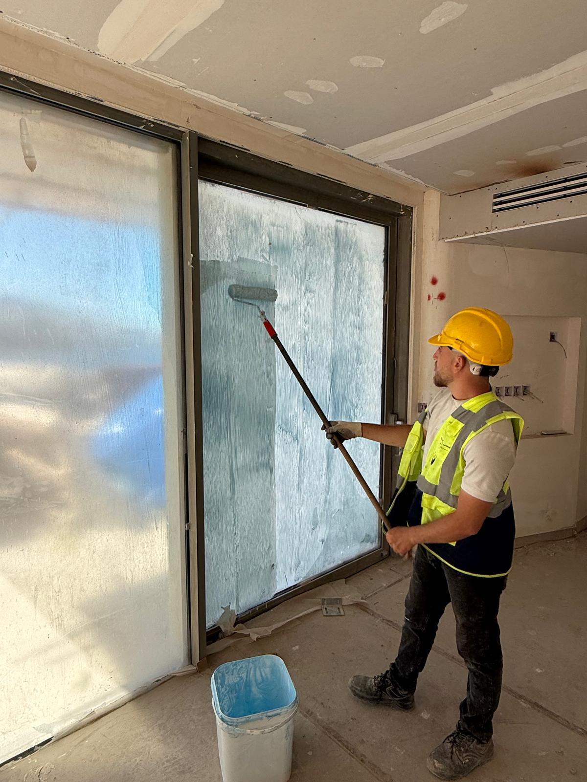 A Koruflex protective coating being applied to a glass surface